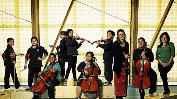 Students from Meadows Primary School build their confidence through music-making with the help of MSO viola teacher Danielle Arcaro (left) and in-school co-ordinator Helen Hatzikalis.