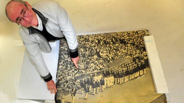 Reg McKay, of Duffy, with a photo of his brother carrying the flag for the Australian Olympic team in 1948.