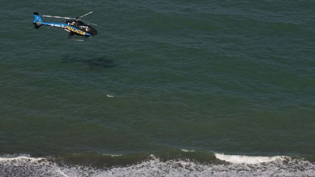 A   police helicopter searches the waters of the Gulf of California for survivors of a capsized fishing boat.