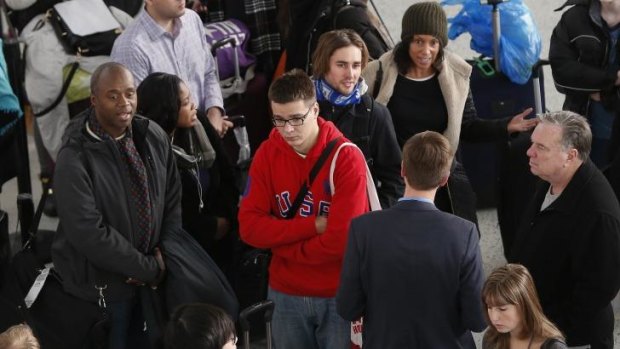 Angry customers gather at the JetBlue counter at New York's John F Kennedy International Airport.