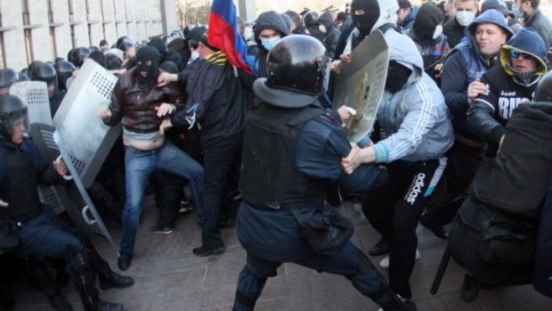 Pro-Russian supporters clash with members of the riot police as they storm the regional administration building in the eastern Ukrainian city of Donetsk.
