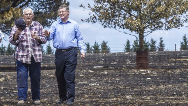 Battle: Phil Makin shows Premier Denis Napthine the damage to his property in Kilmore following last week’s bushfire.