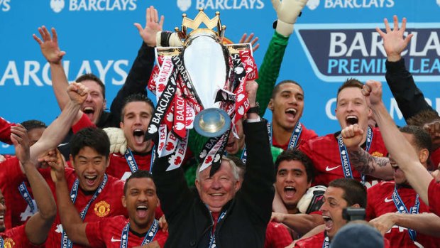 One last title: Sir Alex Ferguson lifts the Premier League trophy.