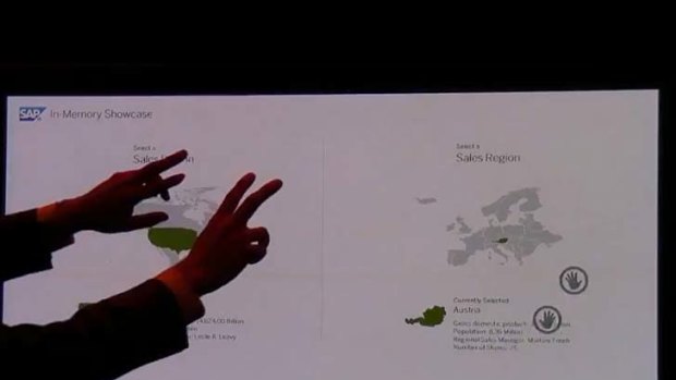 A man uses both hands to change screens and demonstrate SAP's HANA in a video demonstration. He can highlight regions on a map and call for results with gestures, using Kinect.