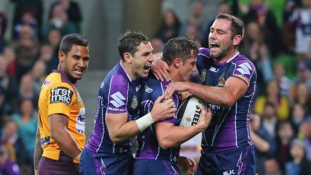 Cooper Cronk is congratulated by Cameron Smith after scoring a try.