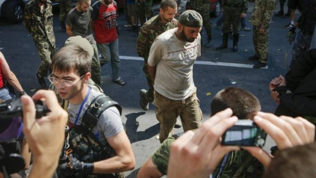 Pro-Russian separatist rebels force-march Ukrainian prisoners across central Donetsk on Sunday.