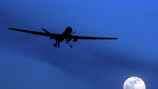 An unmanned US Predator drone flies over Kandahar Air Field, southern Afghanistan, on a moon-lit night.
