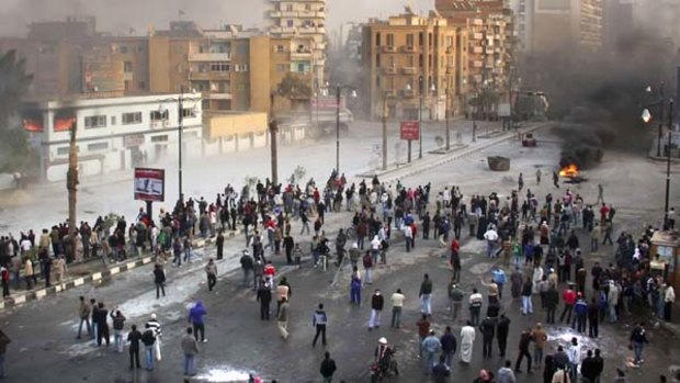 Taking it to the streets ... Egyptians protestors clash with anti-riot policemen in Suez. Activists called for a mass rally in the capital, Cairo.