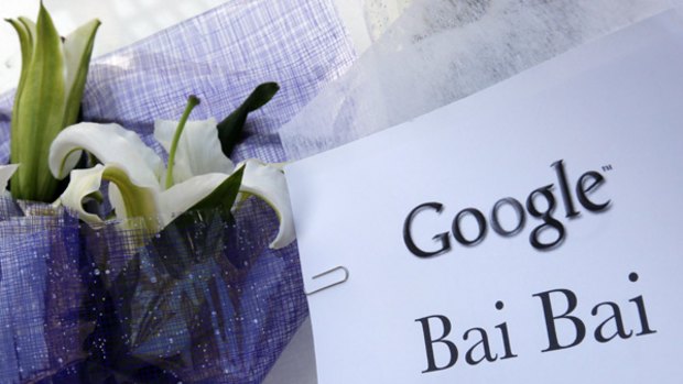 A sign, which reads "Google Bai Bai (bye bye)" is seen near flowers, left by visitors outside the Google China headquarters in Beijing.