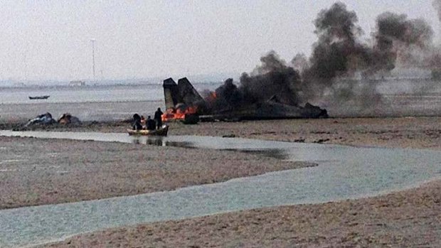 Progress?: The burning wreckage of the aircraft on a mudflat in Shandong.