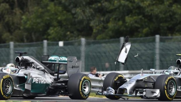Debris flies off Rosberg's car after it collides with Lewis Hamilton's Mercedes. The collision punctured a wheel on Hamilton's car.