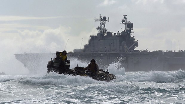 A US Marine Corp amphibious assault vehicle travels through the Pacific Ocean after departing the USS Peleliu, which is alleged to have been used as a floating prison.   PICTURE: AP