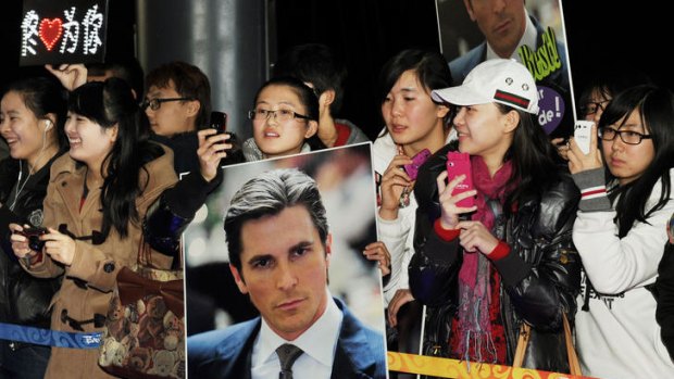 Fans of actor Christian Bale wait as he arrives on the red carpet for the screening <i>The Flowers of War</i> in Beijing earlier this week.
