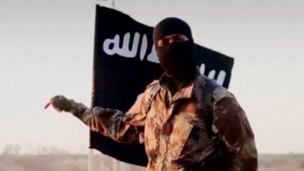 A masked man speaks in what is believed to be a North American accent in a video released by the Islamic State.