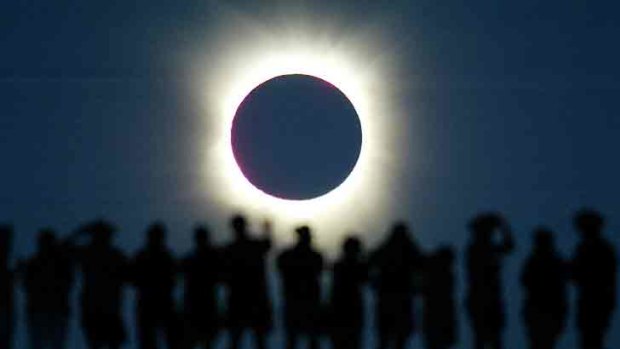 Tourists watch the sun being blocked by the moon during a solar eclipse in the Australian outback town of Lyndhurst, about 700kms north of Adelaide, in late 2002.