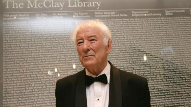 Nobel prize-winning poet Seamus Heaney stands before a large glass panel listing all the benfactors before the offical opening of Queens Unversity's new McClay Library, Belfast.