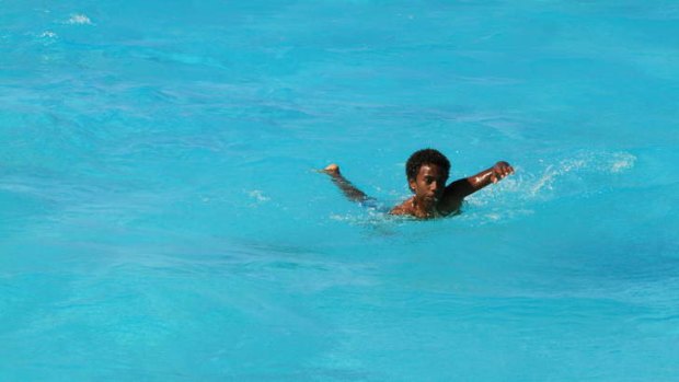 A Kanak boy cools off in New Caledonia.