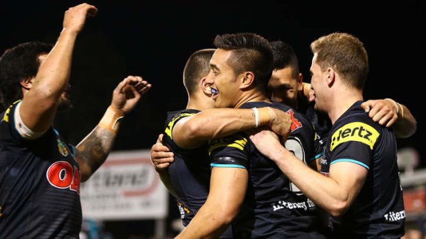 Panthers players celebrate a try by Dallin Watene-Zelezniak against the Warriors.