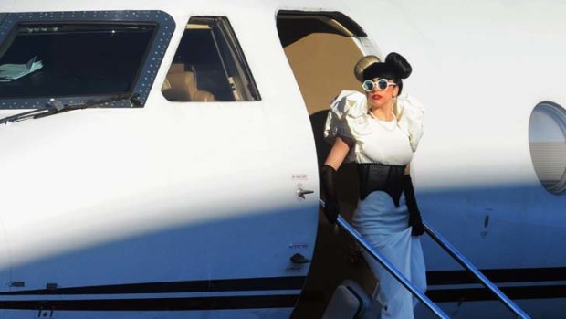 Arrival ... Lady Gaga emerges from her plane 30 minutes after touching down.