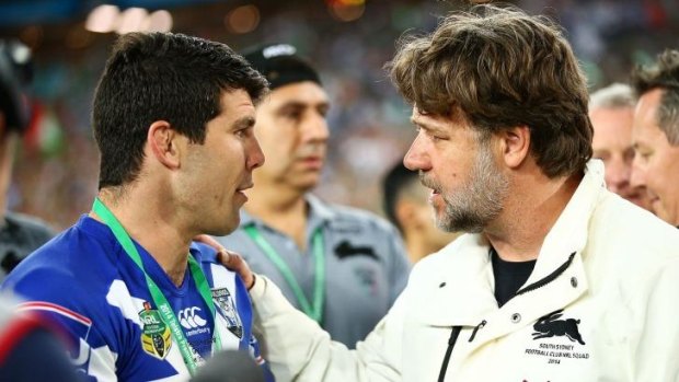 Commiserations: Russell Crowe speaks with injured Bulldogs captain Michael Ennis after Sunday's grand final.
