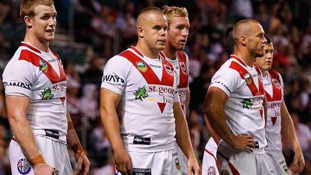 Dejection: Dragons players see their efforts coming to nothing as a try is conceded to the Broncos on Friday night.