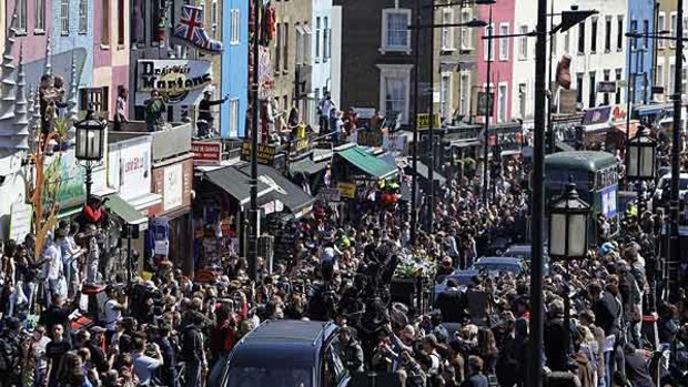 Crowds gather to watch the funeral procession for British music impresario Malcom McLaren in Camden, north London.