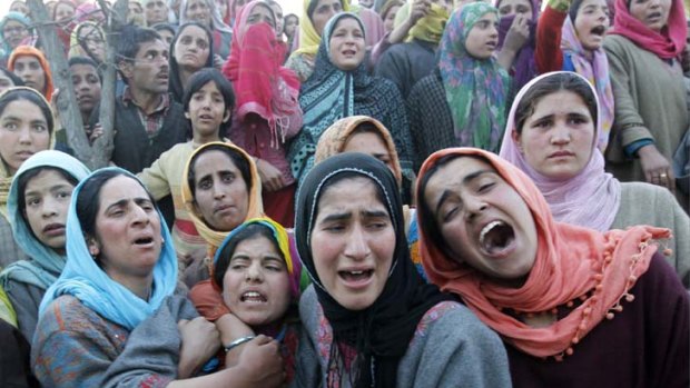 Families scarred by violence ... women mourn at a funeral in Khan Sahib, west of Srinagar, after one person was killed in another militant attack.