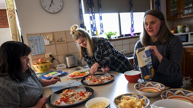 Melanie, Belinda and Jess prepare food for their party to celebrate one year of living together. 