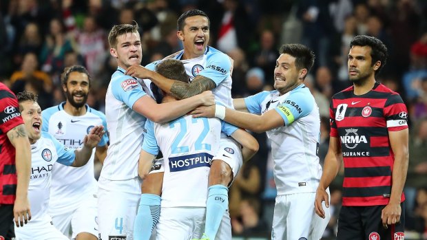 Michael Jakobsen of City is congratulated by Tim Cahill, Bruno Fornaroli and his teammates after scoring.