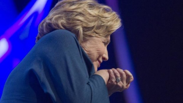 Duck and cover: Former US secretary of state Hillary Clinton ducks as an object is thrown on stage in Las Vegas.