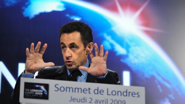 Hands around the world...Nicolas Sarkozy at a press conference after the summit