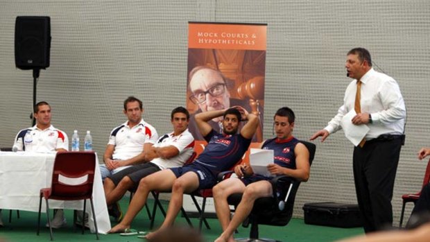 The ball's in your court, boys . . . Roosters players sit in on the 'trial' conducted by Mock Court International at the SCG yesterday. Young halfback Mitchell Pearce played the bad guy.