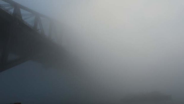 Sydney Harbour Bridge disappears in the fog.