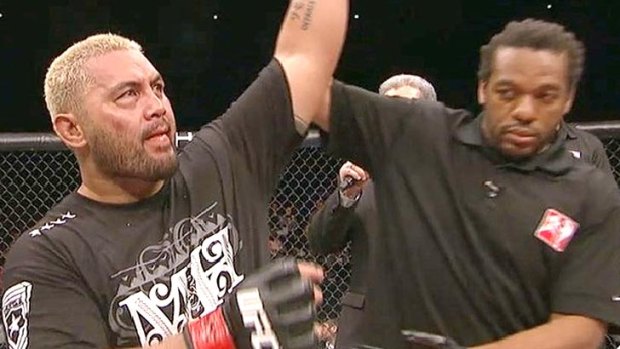 Mark Hunt (left) has his hand raised by referee Herb Dean.