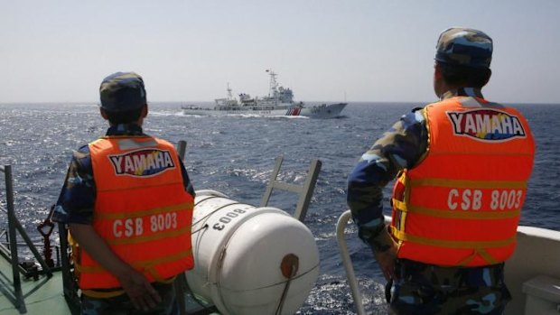 Sharp eye: Vietnamese Marine Guard monitor a Chinese coast guard vessel in the South China Sea in May.