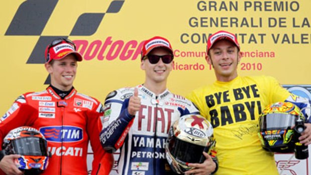 Casey Stoner, Jorge Lorenzo and Valentino Rossi celebrate after the final MotoGP race of the season.