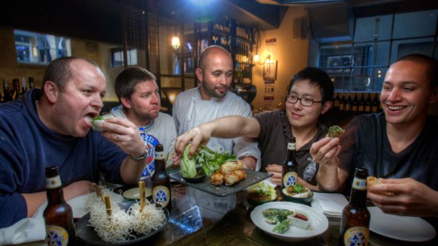 Chef Adam D'Sylva serves some dude food to Coda staff members Matthew Lawdorn, Joel Crowther, Henri Budiman and Alan Timu.