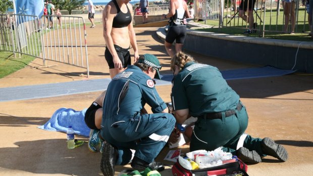 Paramedics treat a woman after allegedly being hit by a drone.