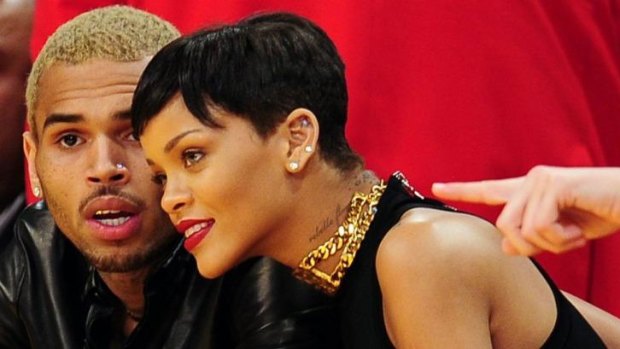 Happier times ... Chris Brown and Rihanna attend an NBA  game in 2012.