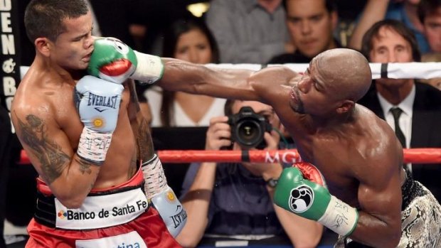 Under investigation: Floyd Mayweather (R) during his title defence against Marcos Maidana.