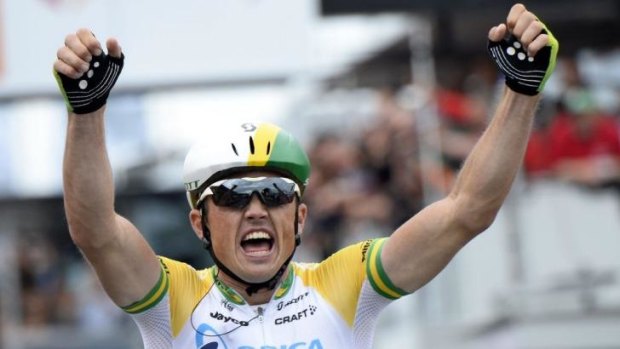Simon Gerrans celebrates as he crosses the finish line and wins the 100th edition of the Liege-Bastogne-Liege one-day classic.