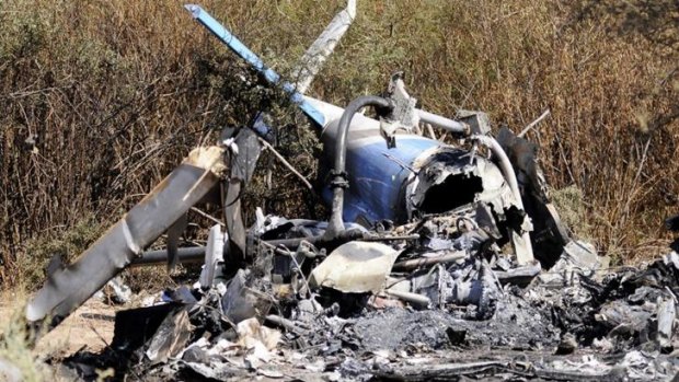 The charred wreckage of the two helicopters which collided.