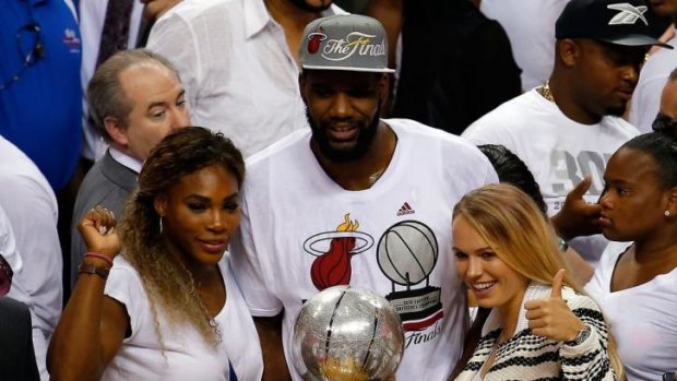 Serena Williams and Caroline Wozniacki on court with Greg Oden after game six.