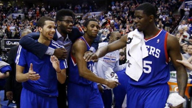 Drought-breaker: Philadelphia 76ers players Michael Carter-Williams, Nerlens Noel, Hollis Thompson and Henry Sims celebrate in the final seconds of the win over Detroit in March, which broke a 26-game losing streak.