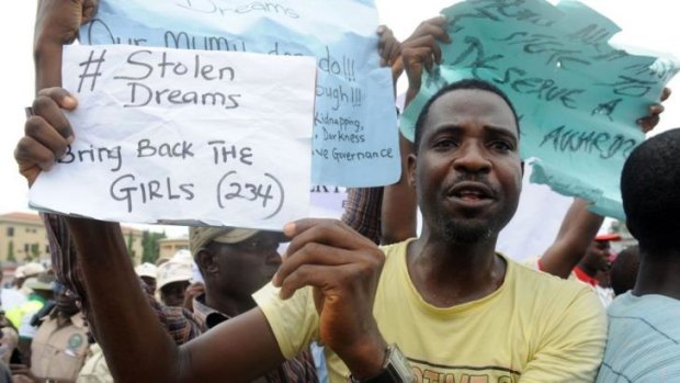 A man carries placard to campaign for the release of schoolgirls kidnapped by Boko Haram Islamists more than two weeks ago during worker's rally in Lagos.