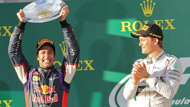 Grinners: Melbourne grand prix winner Nico Rosberg (right) applauds Australian runner-up Daniel Ricciardo.