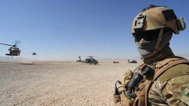 A Special Operations Task Group soldier waits for US Black Hawk helicopters to land at Tarin Kowt airfield in Afghanistan.