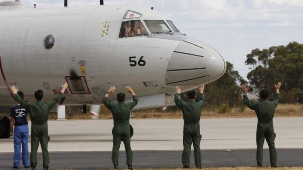 Members of the Japan Maritime Self-Defence force farewell a P-3C Orion at RAAF Base Pearce, Perth.