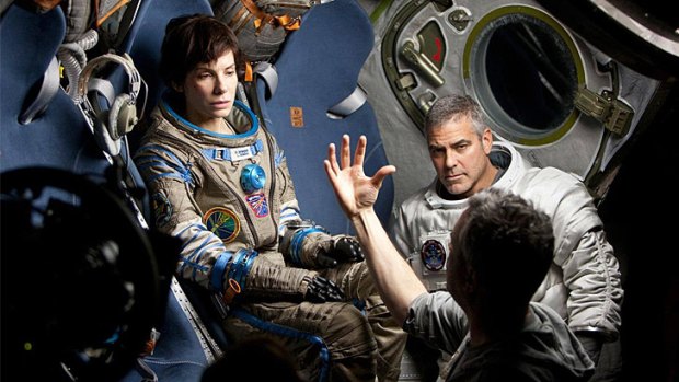 Astronomical bucks ... Sandra Bullock and George Clooney during the filming of Alfonso Cuarón's space epic <i>Gravity</i>.