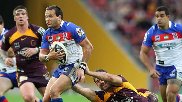Tyrone Roberts attempts to break away during the round 13 NRL match between the Brisbane Broncos and the Newcastle Knights.